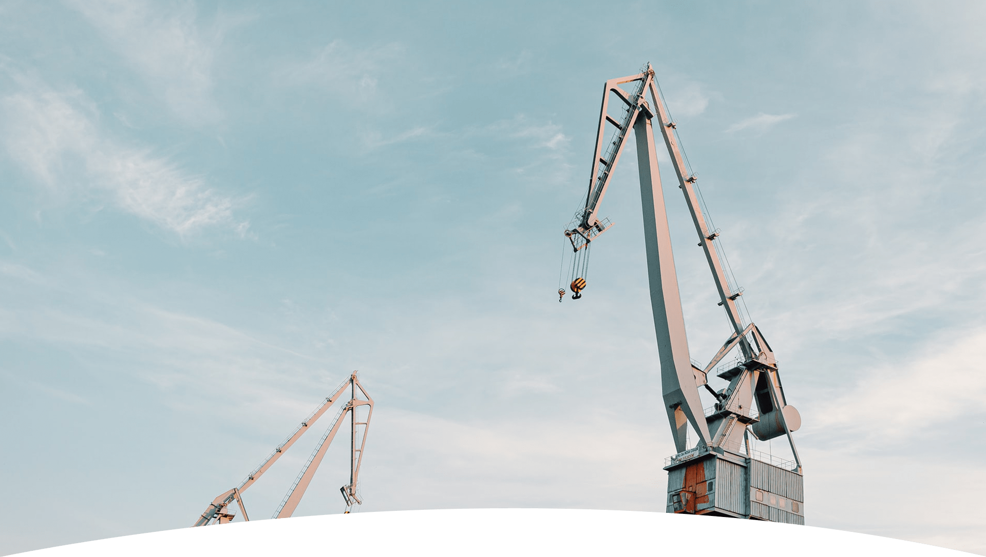 Mobile crane boom raised against a blue sky